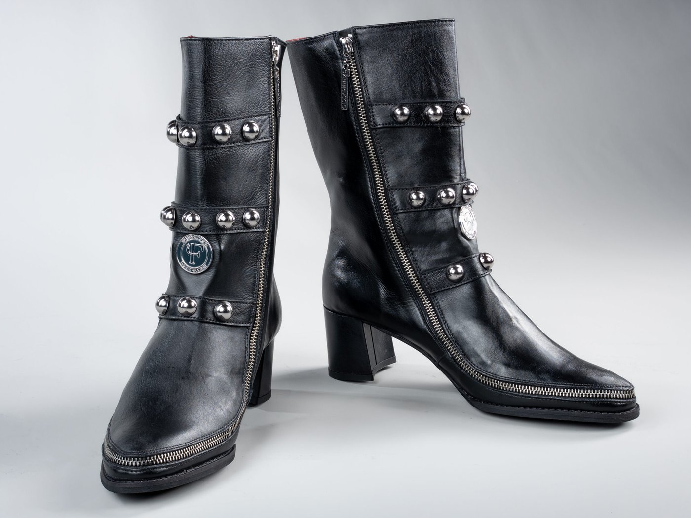 Vivienne Black, three-quarter view showing cast brass logo medallion